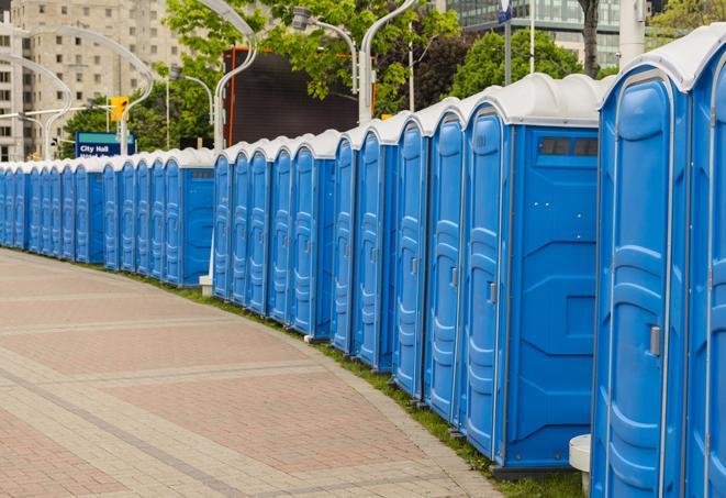 a row of portable restrooms set up for a special event, providing guests with a comfortable and sanitary option in Brighton